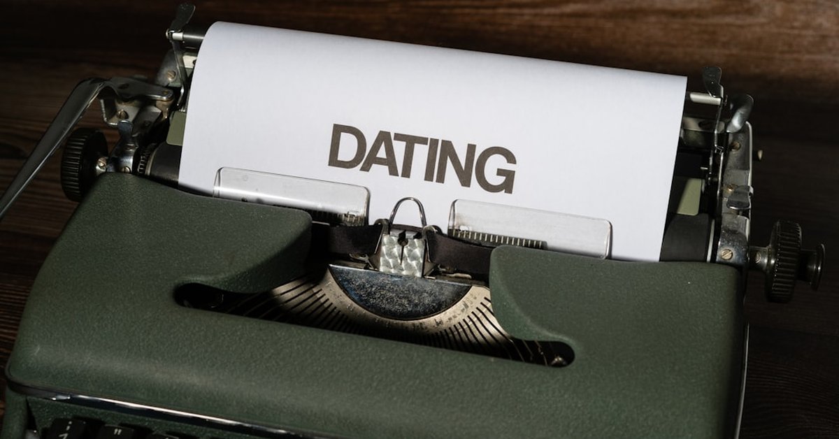 A person conducting online research for background checks, using a laptop and notepad in a cozy environment.